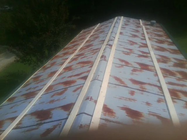 Rusted metal roof panels with new wood purlins before replacement — Storm Damage Roof Repair in Elora by Roofing Brothers
